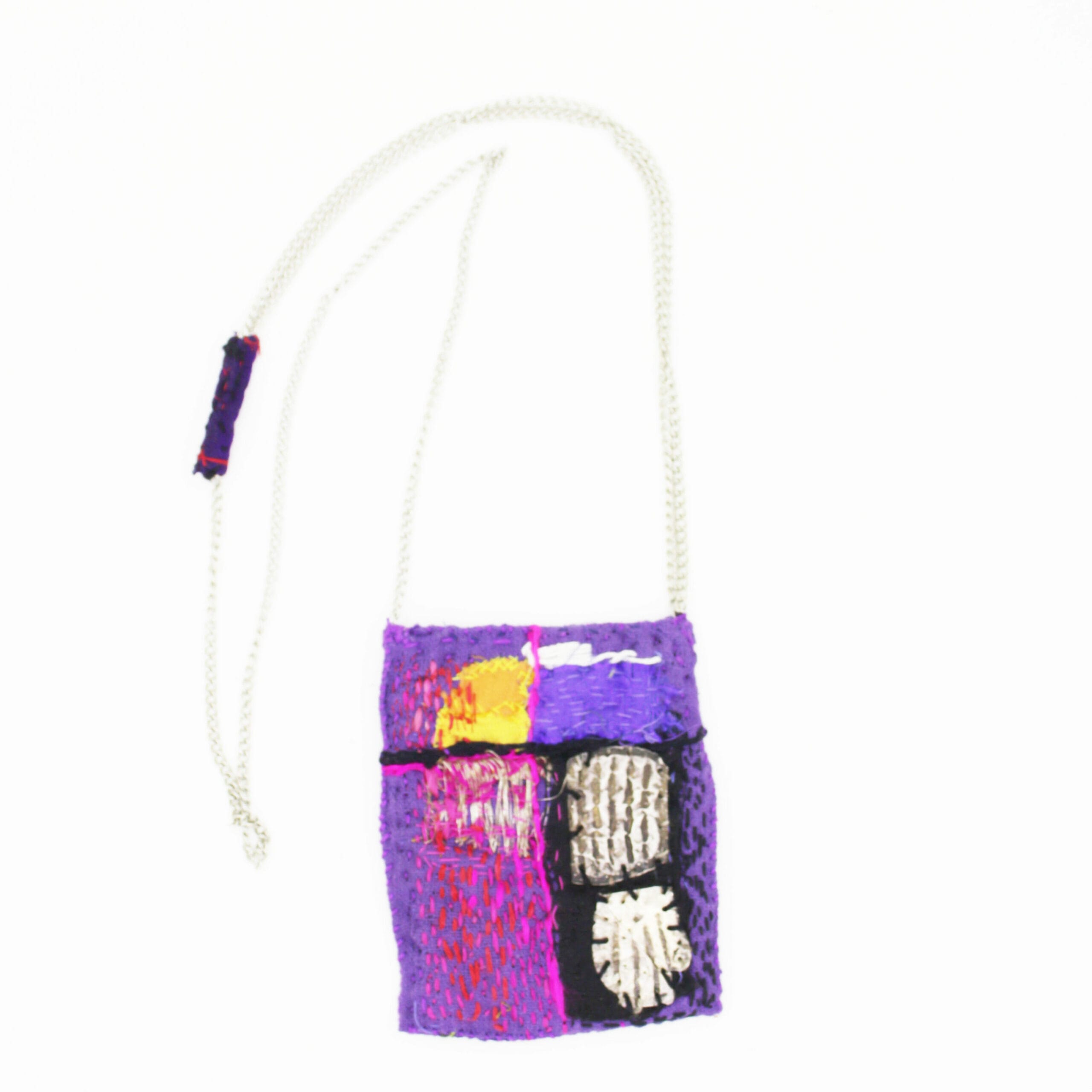 Pendant with silver and old fabrics